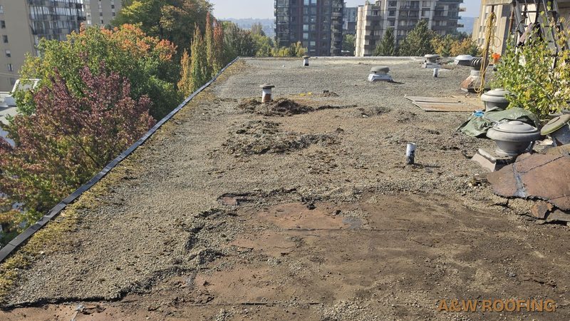 Old gravel roof along the parapet before tear-off, West End, Vancouver, A&W Roofing Ltd